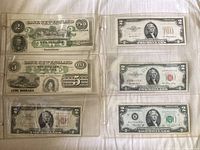 Front of album page showing Bank of New England notes and multiple U.S. two-dollar bills.