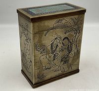 Angled front-right view showing hand-chased figural scene on one side