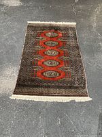 Full view of the rectangular area rug laid flat showing overall design and color.