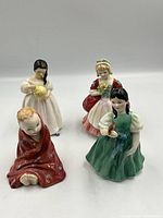 Four Royal Doulton figurines, multiple angles showing details and paint colors.