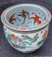 Interior view showing painted koi and lotus motif with geometric and floral border at rim