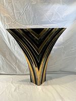 Front angled view showing bold black and gold chevron design and flared top shape