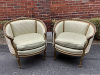 Front view of the pair showing overall shape, upholstery and frame