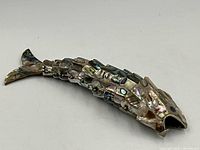 Full view of the articulated abalone shell fish sculpture showing segmented shell pieces and overall shape.
