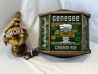 Genesee Cream Ale light and Schlitz light shown together from front, showing front face and cords.