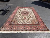 Full view of rug laid flat on pavement showing overall pattern and color.