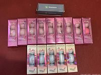 Multiple unopened pink boxes of Pinnacle Lady Susan G.Komen for the Cure branded golf balls, each containing 3 balls.