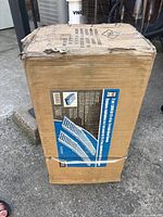 Closed cardboard box packaging for two tri-fold steel ramps showing product image and basic specs.