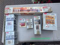 Photo of Rubbermaid Metal Master Kit storage system and assorted parts bins and hardware organizers boxed and loose on ground.