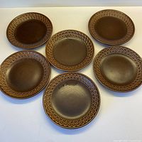 Six brown Wedgwood Pennine dessert plates laid out to show full set