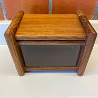 Front top view closed showing teak construction and acrylic window