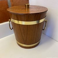 Full view of teak ice bucket with lid and brass hardware