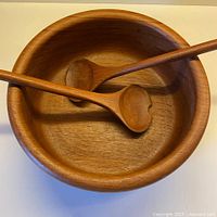 Top view of teak bowl with two servers inside