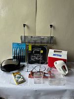 View of all items included in kitchen and miscellaneous bundle laid out on white surface.