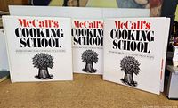 Three McCall's Cooking School cookbooks arranged side by side showing front covers with title and vegetable illustration.