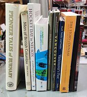 Photo showing all 10 books standing upright, titles visible: Pioneer Tales of Burnaby, Men of British Columbia, Hockey Day in Nelson, and others relating to local history and regions of British Columbia and Vancouver.