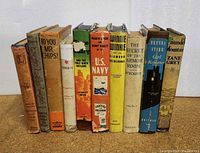 Photo of ten vintage children's books showing varied titles including The Wind in the Willows, Brenda Starr Reporter, and others, all in fair to good condition.