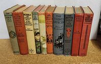 Photo of all 10 vintage children's hardcover books lined up showing titles and condition.