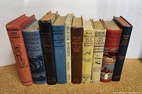 Photo of 10 vintage children's books lined up side-by-side showing spines and covers for identification