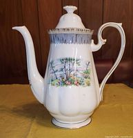 Front and left side view of the Royal Albert Silver Birch coffee pot showing detailed painted scene and spout shape.