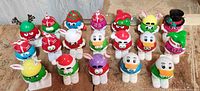 Front view of 19 M&M's collectible figures standing in rows showing colorful details and removable hats.