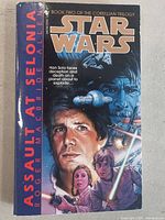 Front cover of the Star Wars Assault at Selonia paperback book showing main characters and title.