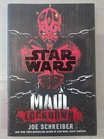 Front cover of Star Wars Maul Lockdown hardcover book featuring Darth Maul in chains with dark background.