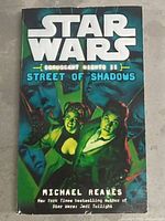 Front cover of the Star Wars book titled 'Coruscant Nights II: Street of Shadows'. Shows illustrated characters and book title.