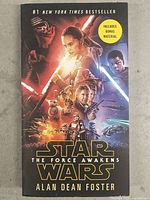 Front cover of the paperback novel Star Wars The Force Awakens by Alan Dean Foster featuring main characters and branding.