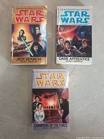 Front covers of three Star Wars books from the Jedi Academy trilogy showing different characters and scenes.