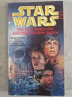 Front cover of Star Wars The New Rebellion paperback book showing main characters and title.