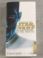 Front cover of the hardcover book titled 'Star Wars Thrawn' by Timothy Zahn with character face artwork.