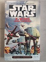 Front cover view showing Star Wars X-Wing Isard's Revenge with artwork of Star Wars spacecraft including X-wing fighters and AT-AT walker.