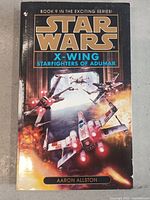 Front cover of Star Wars X-Wing Starfighters of Adumar showing space battle illustration with starfighters.