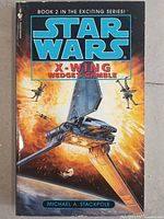 Front cover of Star Wars X-Wing Wedge's Gamble Book 2 sci-fi novel showing detailed space combat artwork.