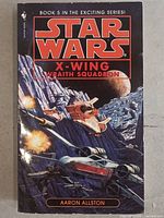 Front cover of 'Star Wars X-Wing Wraith Squadron' book showing artwork with starships and planetary background.