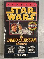 Front cover of the vintage paperback 'Classic Star Wars The Lando Calrissian Adventures' showing title, author, and illustration of Lando Calrissian with Millennium Falcon.