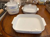 Overhead view of three Cornflower Blue ceramic dishes (two without lids in front and one with lid at back)