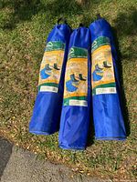 Three royal blue ESCORT folding camping chairs folded in carrying bags, with visible front label showing chair image and product details.