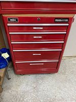 Full front view of red Mastercraft tool chest showing four drawers, wood top and caster wheels.