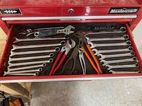 Full view of drawer containing wrenches and pliers laid out on foam liner inside Mastercraft tool chest drawer.