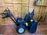 Side profile of complete snow blower in shed