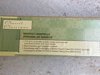 Close-up of the product box with specifications and branding of The Kingsley Collection Classic market umbrella.