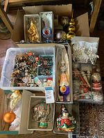Overall view of multiple boxes and trays containing ornaments and toppers