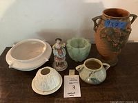 Overall view of all six ceramic pieces including vase, pots, bowl, lamp shade, and figurine