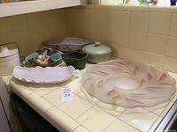 All seven pieces shown on kitchen counter displaying varied vintage decorative bowls and dishes.