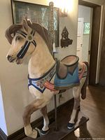 Full view of entire carousel horse showing stance, saddle, and pole mount.