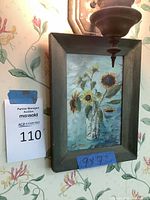 Framed oil painting of sunflowers in a vase with auction lot number 110 visible