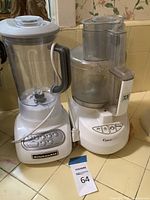 KitchenAid blender and Cuisinart food processor side by side on countertop.
