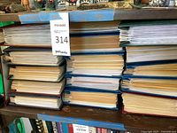 Two stacks of hardcover plastic-sleeve albums on wooden shelving